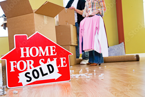 Moving: Home For Sale Sign Sits In Front Of Packing Supplies