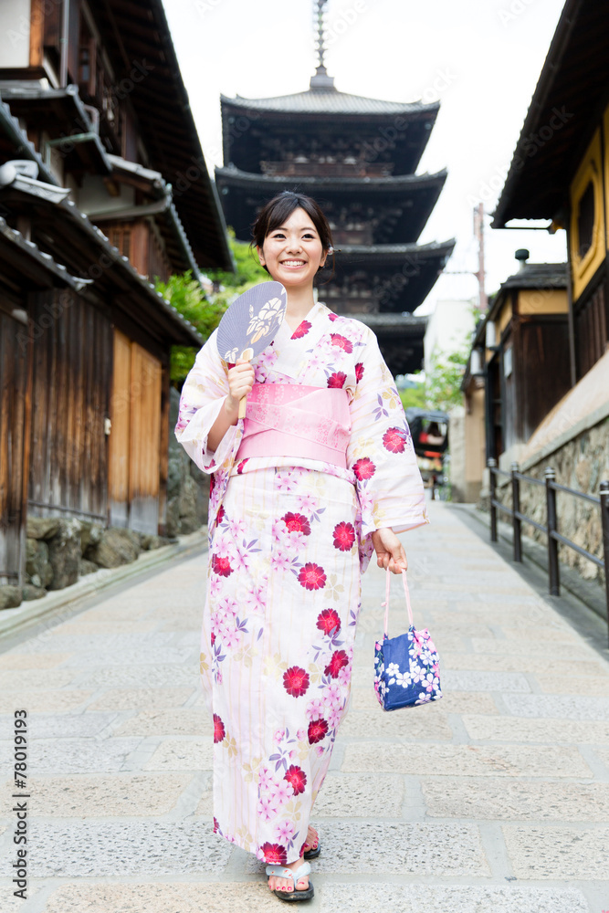 young asian woman wearing kimono walking