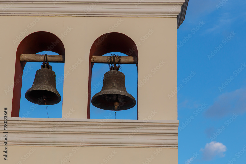 Obraz premium two bells from church with sky at background