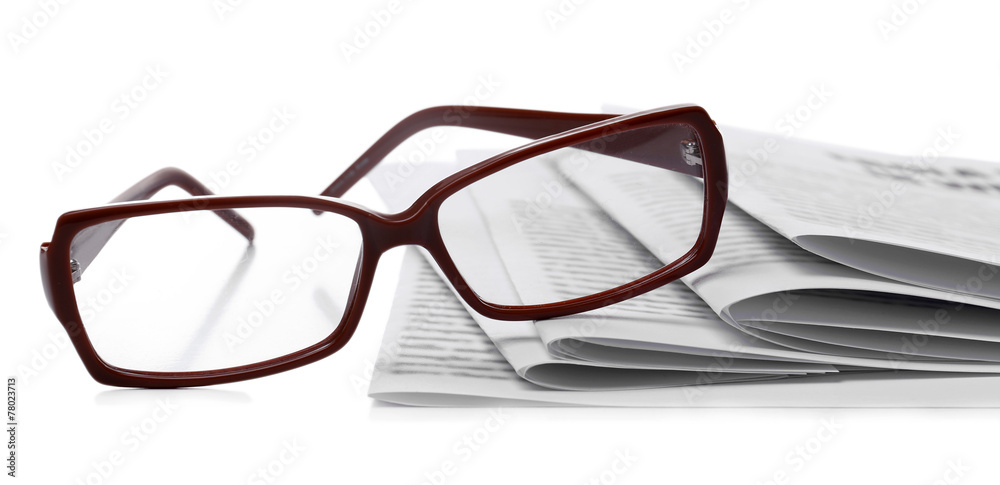 Glasses and newspapers, close-up