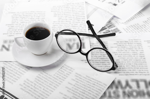 Glasses and newspapers, close-up