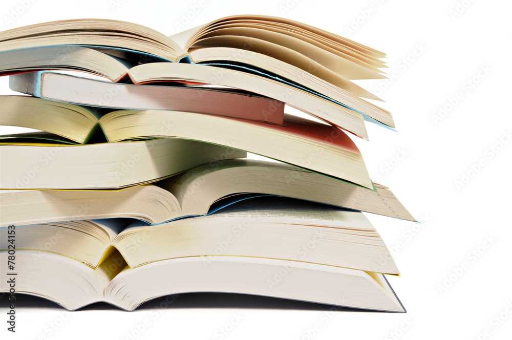 Fototapeta premium Untidy stack or pile of colorful paperback books isolated white background photo