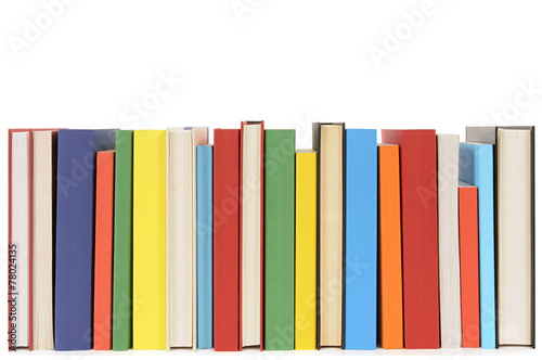 Small row line of colorful books spine facing library collection isolated white background photo