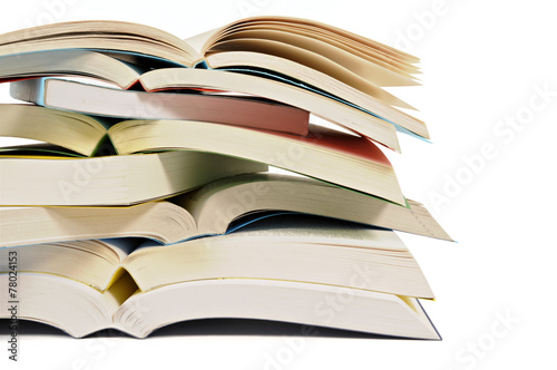 Untidy stack or pile of colorful paperback books isolated white background photo photo