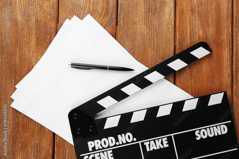 Fototapeta premium Movie clapper with sheets of paper and pen