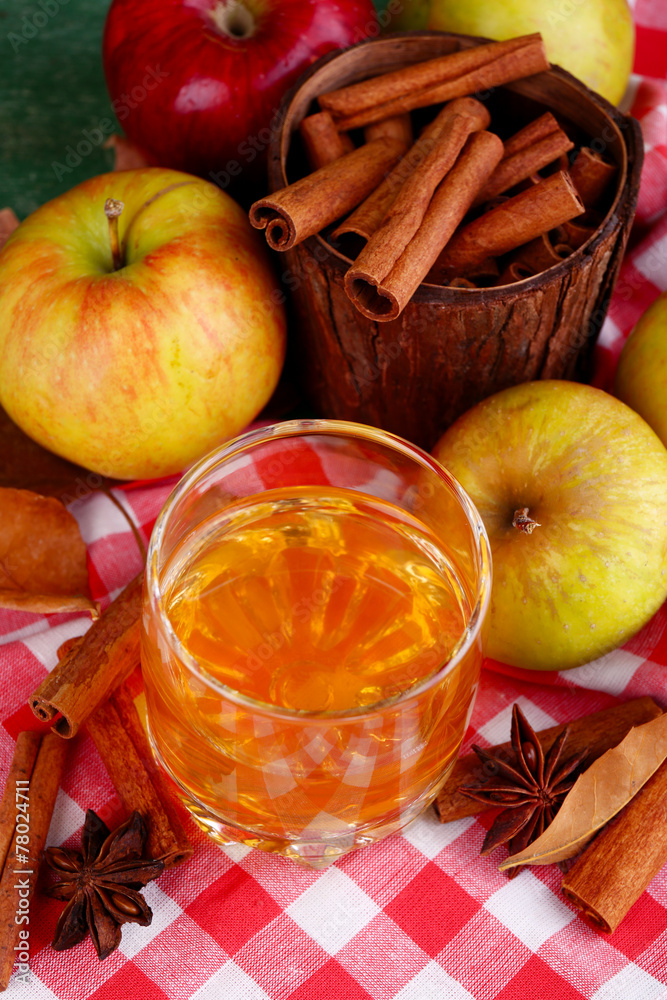 Composition of  apple cider in glass with cinnamon sticks,