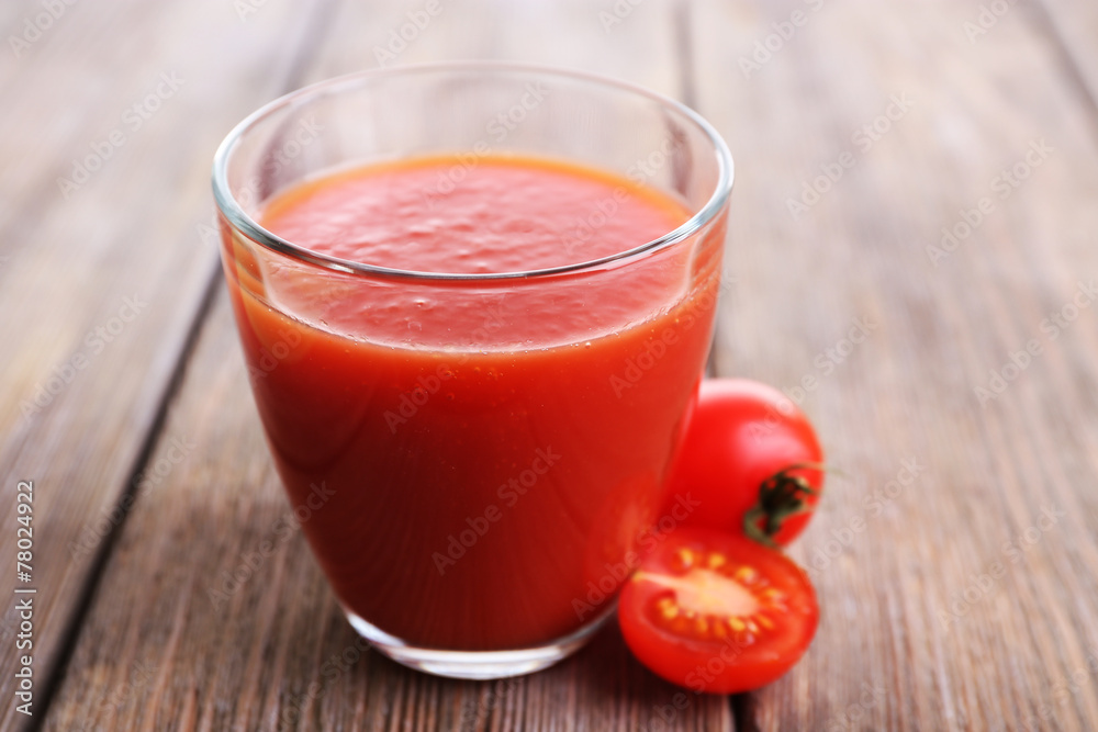 Tomato juice in glass with slice of tomato cherry Tomato juice in glass with slice of tomato cherry