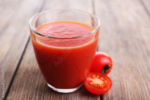 Tomato juice in glass with slice of tomato cherry