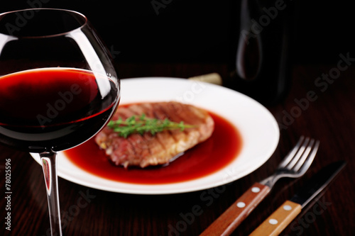 Glass of wine with grilled steak in wine sauce