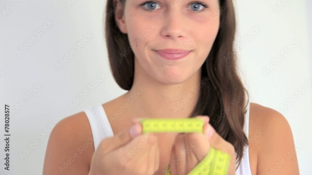 Young woman holding measuring tape Young woman holding measuring tape