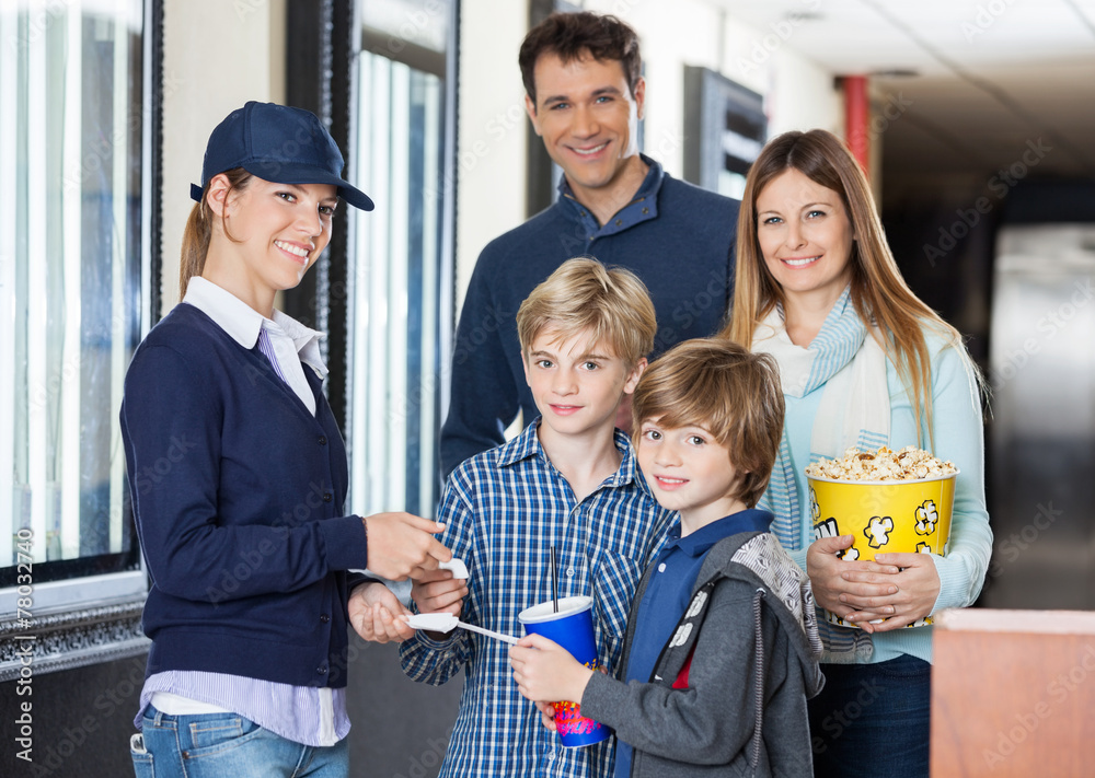 Happy Family Getting Tickets Checked By Worker At Cinema Happy Family Getting Tickets Checked By Worker At Cinema