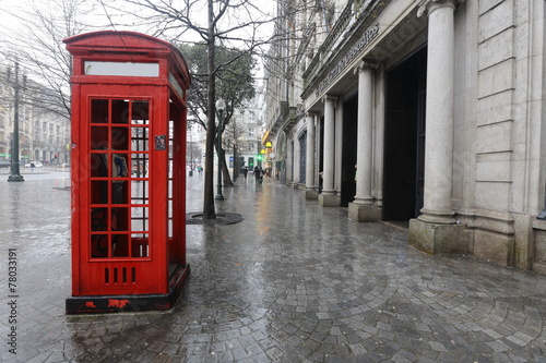 Red telephone booth in the rain