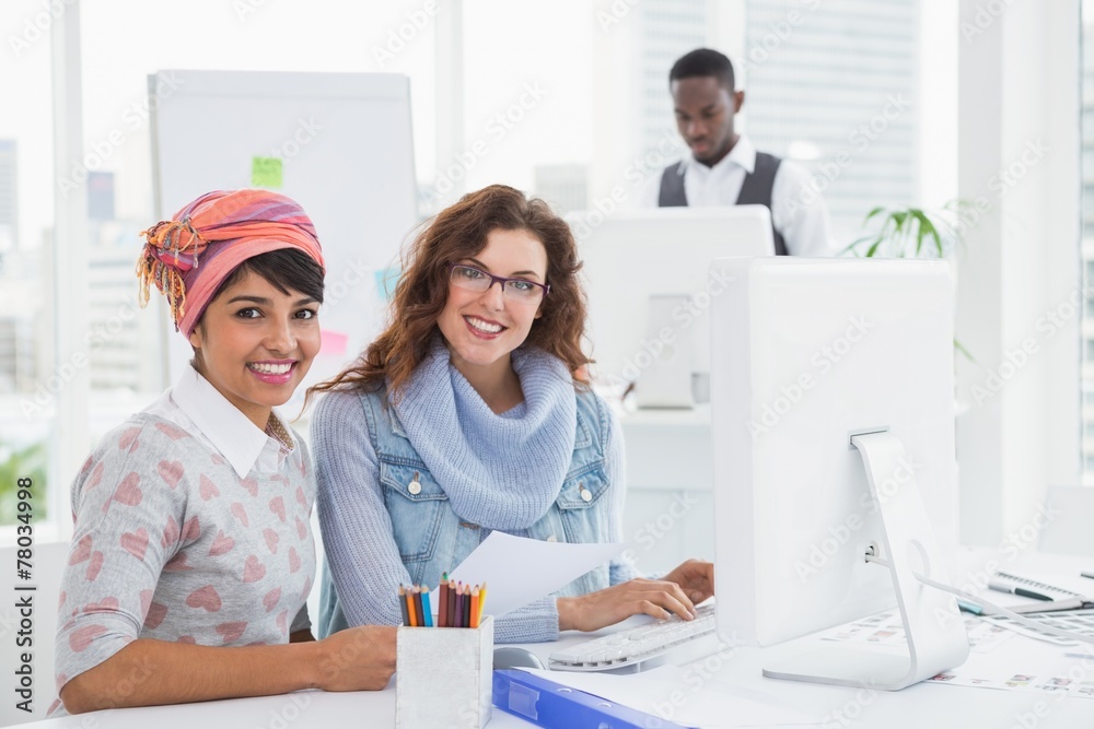 Fototapeta premium Portrait of smiling teamwork sitting at desk