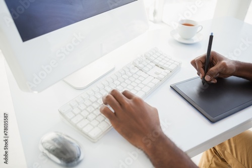 Businessman using computer and digitizer