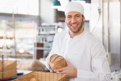 Happy baker with loaf of bread