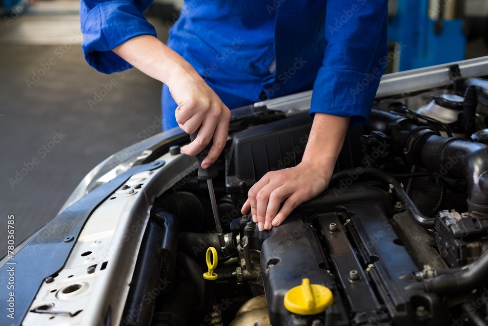 Mechanic working under the hood Mechanic working under the hood