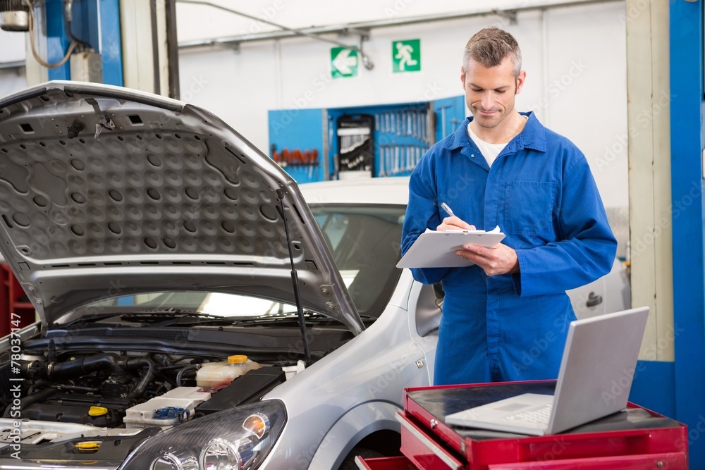 Mechanic writing on clipboard Mechanic writing on clipboard