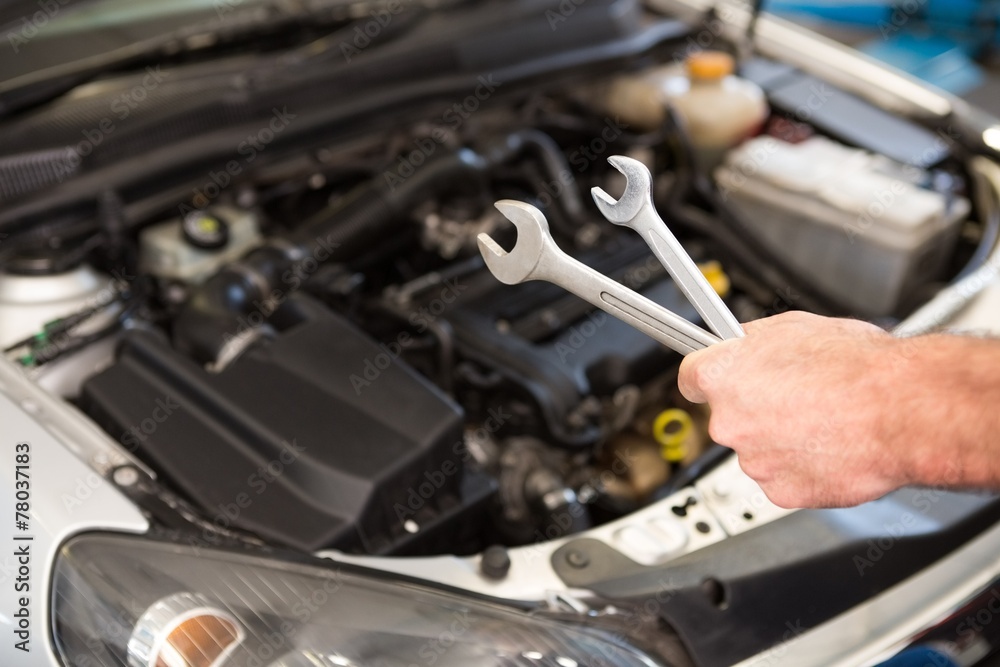 Mechanic holding two types of wrench