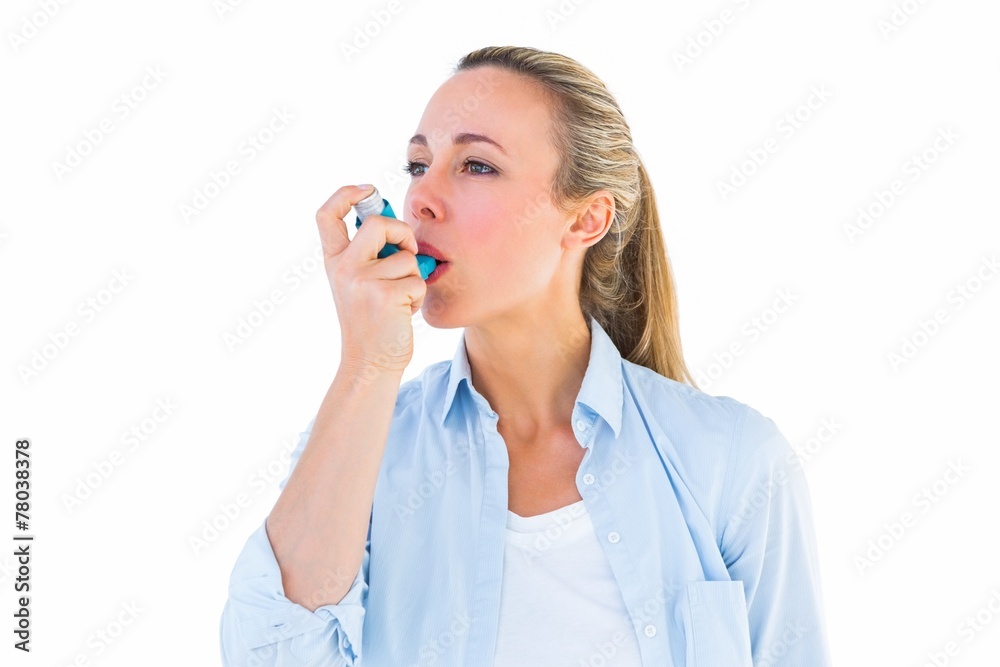 Pretty blonde using an asthma inhaler Pretty blonde using an asthma inhaler
