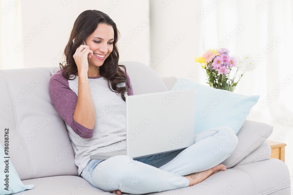 Pretty brunette using her laptop Pretty brunette using her laptop