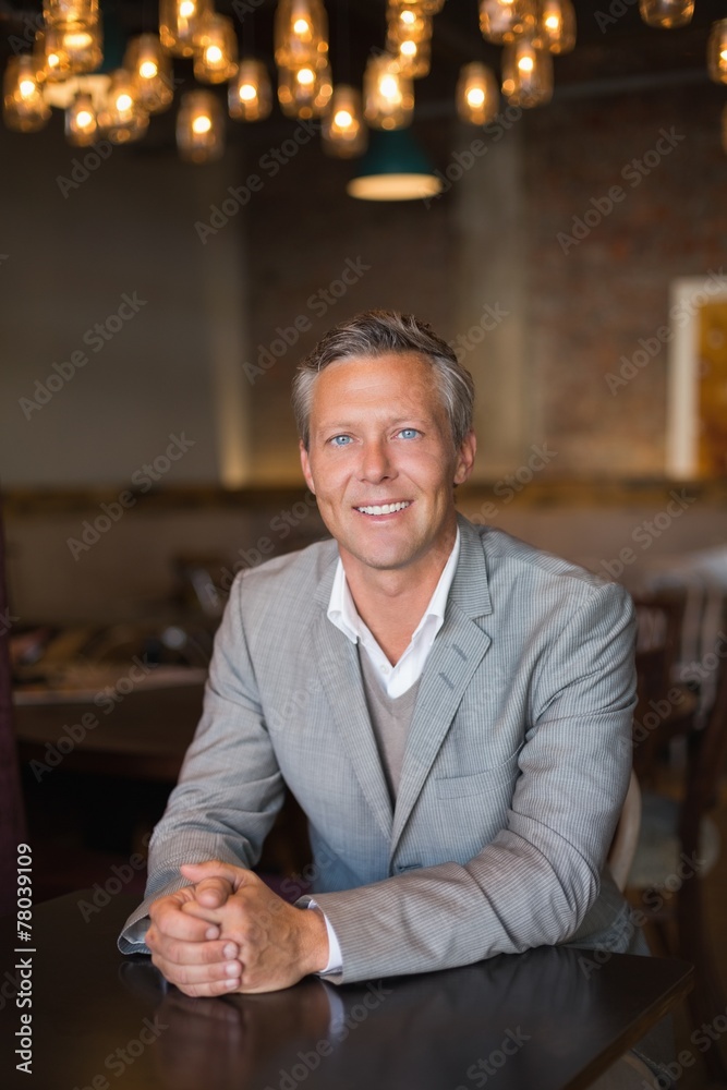 Fototapeta premium Handsome businessman smiling at camera