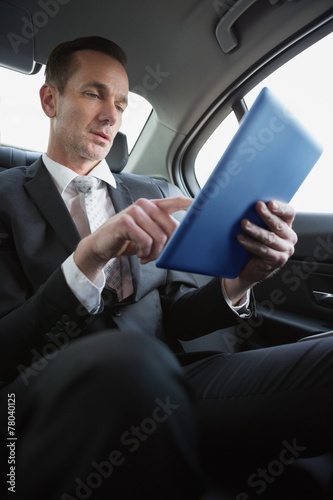Handsome businessman using his tablet pc © WavebreakMediaMicro