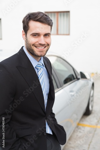 Young businessman smiling at camera