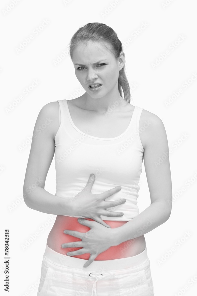 Suffering woman placing her hands on her stomach Suffering woman placing her hands on her stomach
