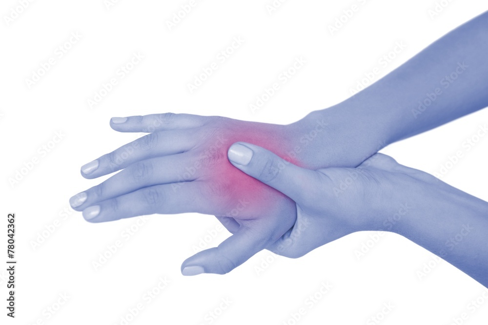 Young woman touching her injured hand Young woman touching her injured hand