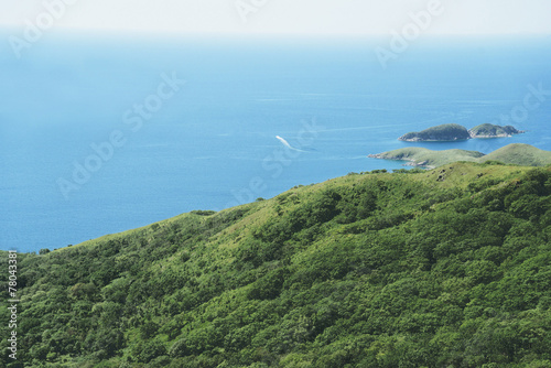 Motor boat sails on the sea from island