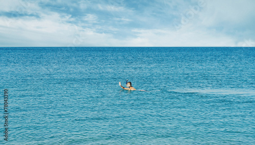 Girl snorkeling in mask in the sea