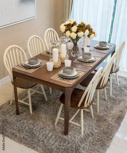 dining table and comfortable chairs in modern home with elegant