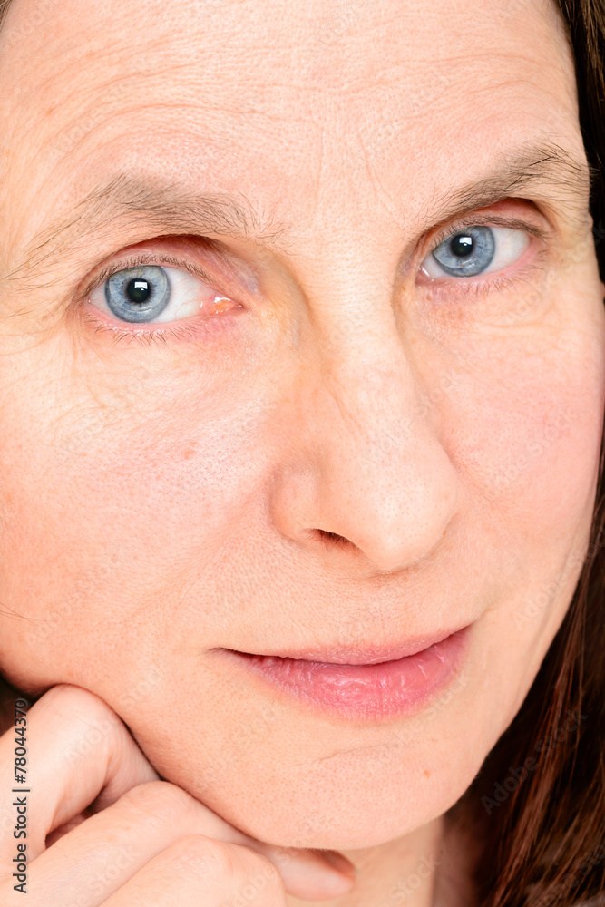 Closeup of adult woman face with soft contact lenses on the eyes