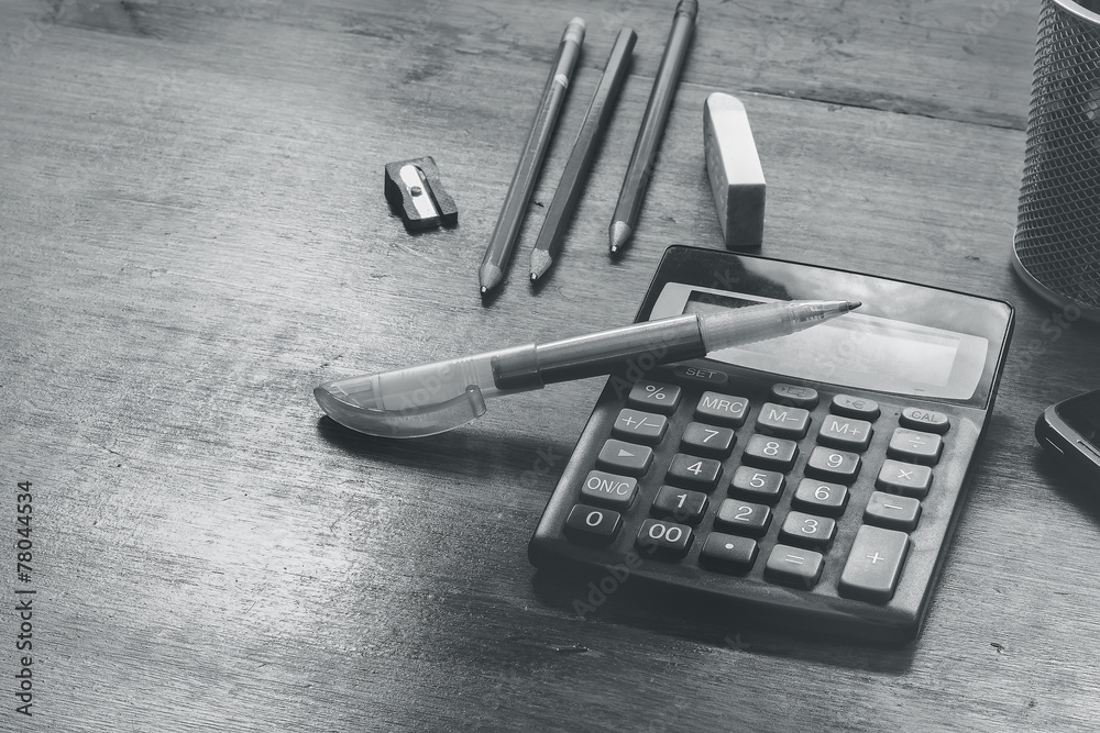 calculator and pencil on a table