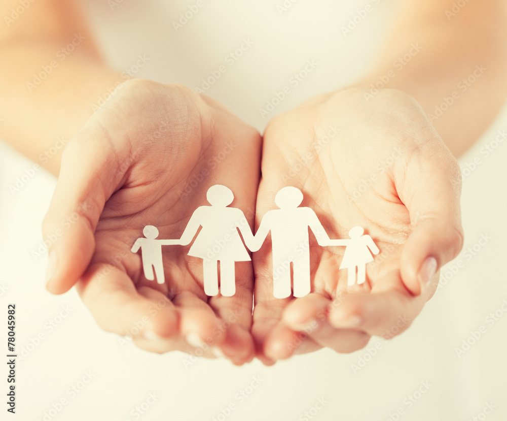 womans hands with paper man family womans hands with paper man family