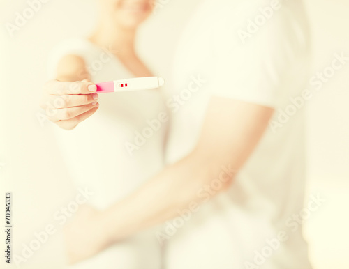 woman and man hands with pregnancy test
