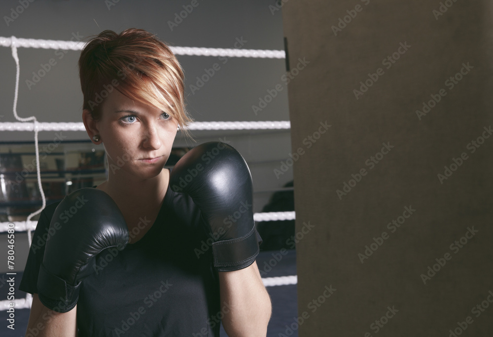 fitness woman doing punching exercises in training place
