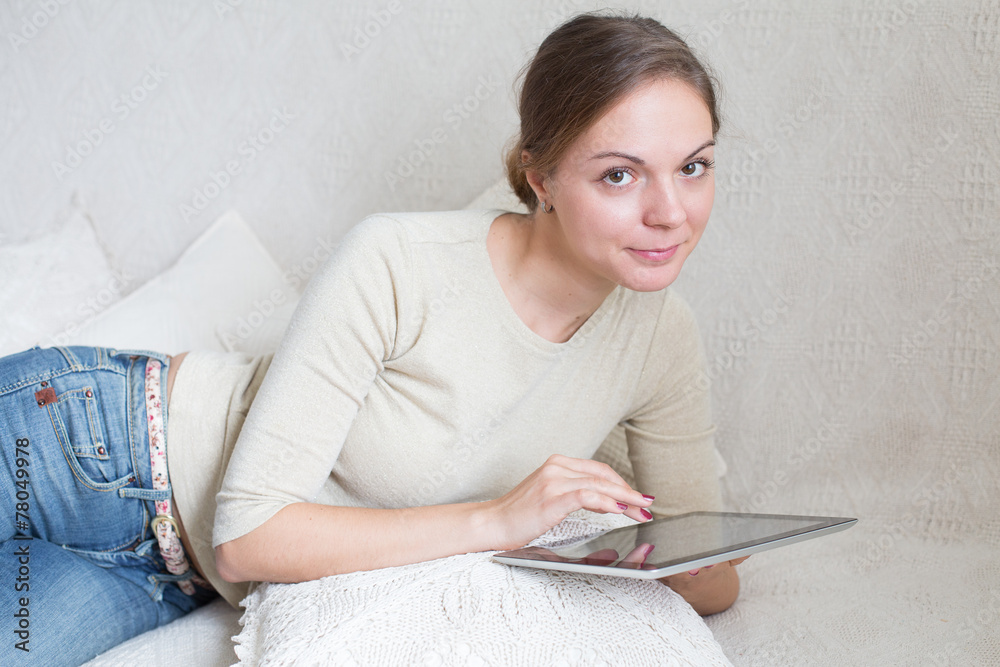 Young woman with touchpad searching something Young woman with touchpad searching something