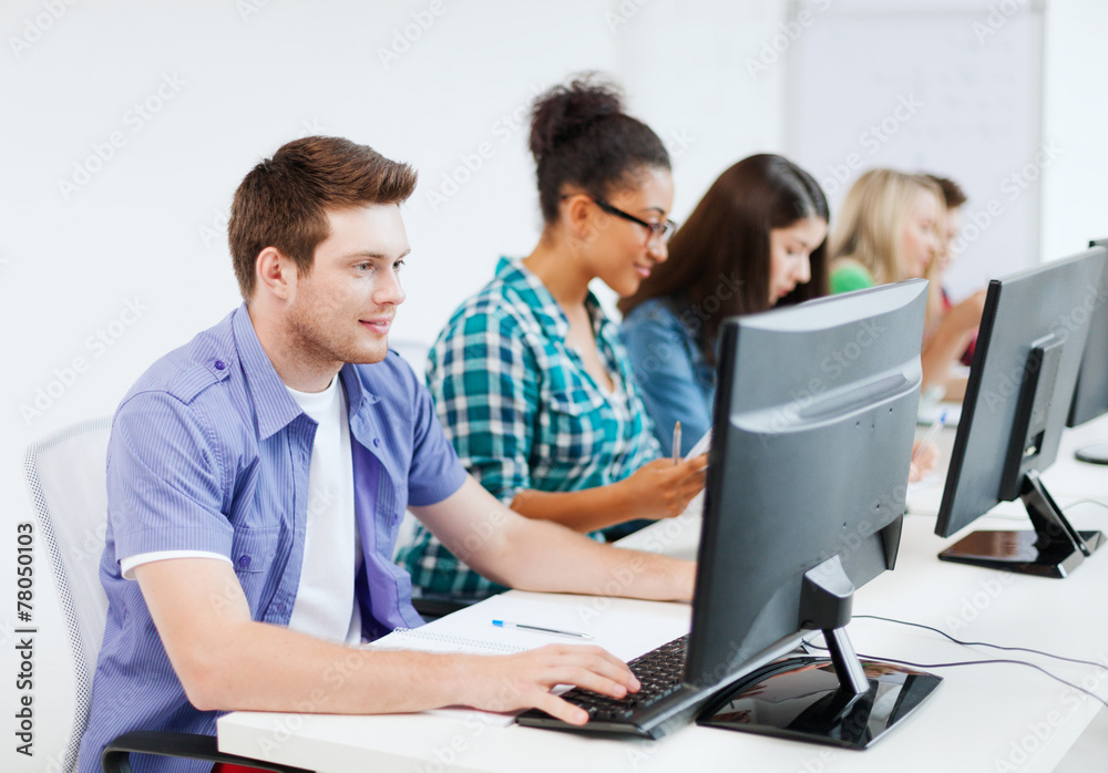 student with computer studying at school