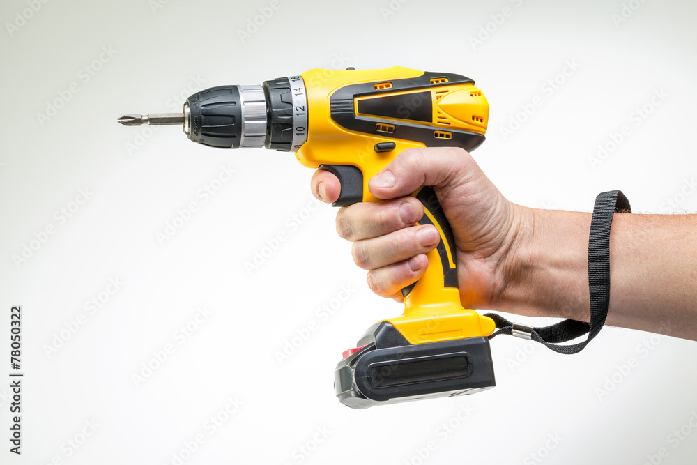electric screwdriver in his hand