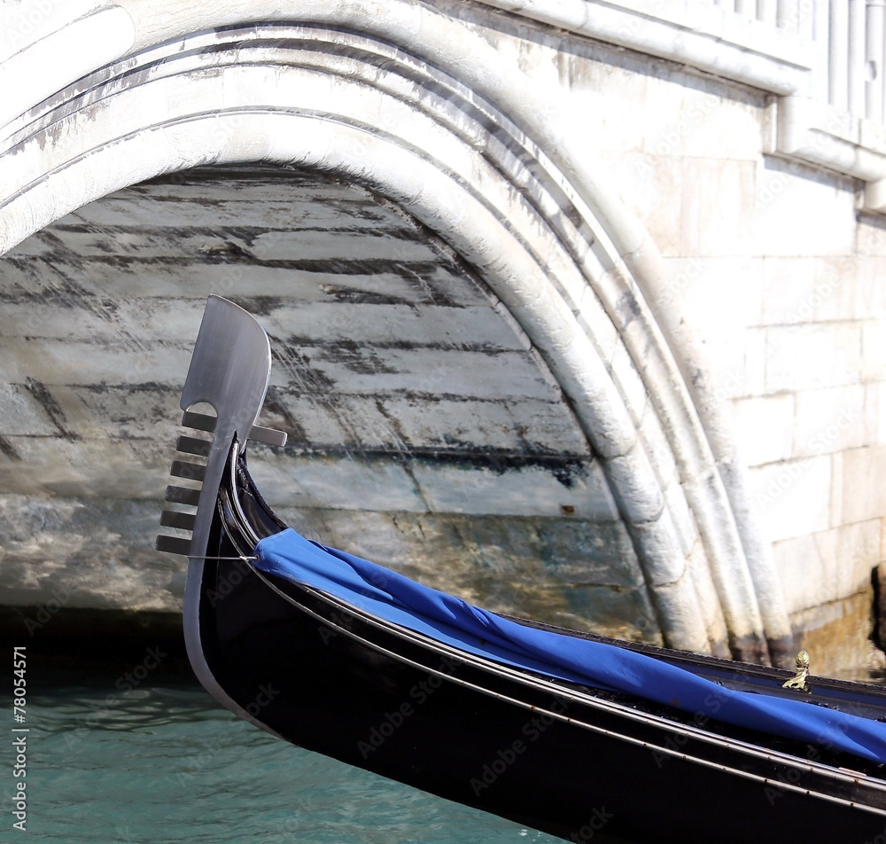 venice, bow of gondola under the bridge in the waterway