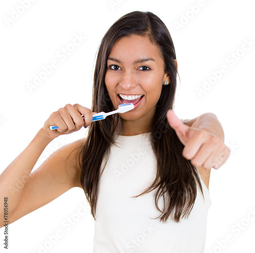 Closeup headshot young happy woman brushing teeth