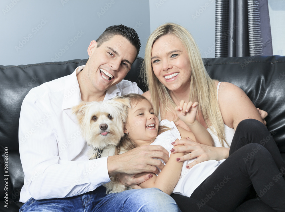 A Family with pets sit on sofa at home A Family with pets sit on sofa at home