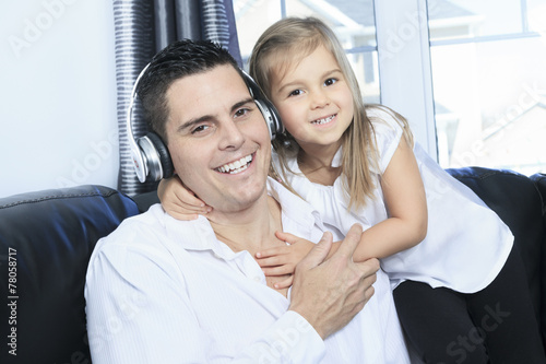 A Father and daughter listening to music