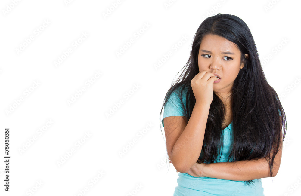 Scared anxious young woman biting fingernails white background Scared anxious young woman biting fingernails white background