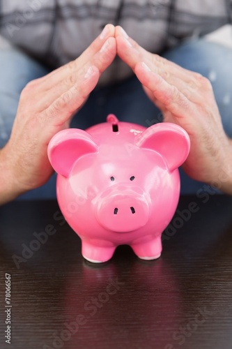Smiling man with piggy bank