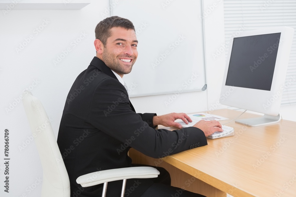 Smiling businessman working at a desk Smiling businessman working at a desk