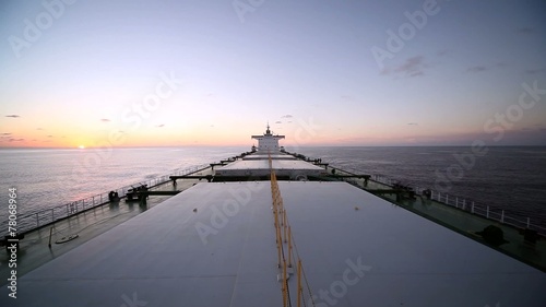 Bulk carrier ship underway at sunset