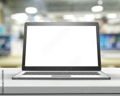 Laptop with blank screen on wood table and blurred background