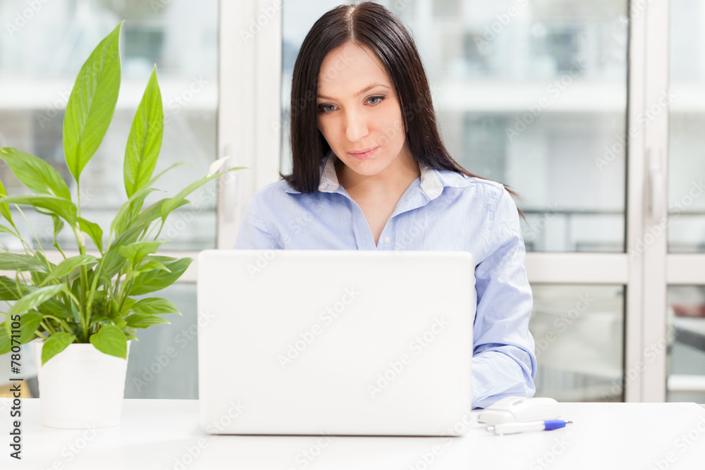 Brunette businesswoman with notebook working in home office Brunette businesswoman with notebook working in home office